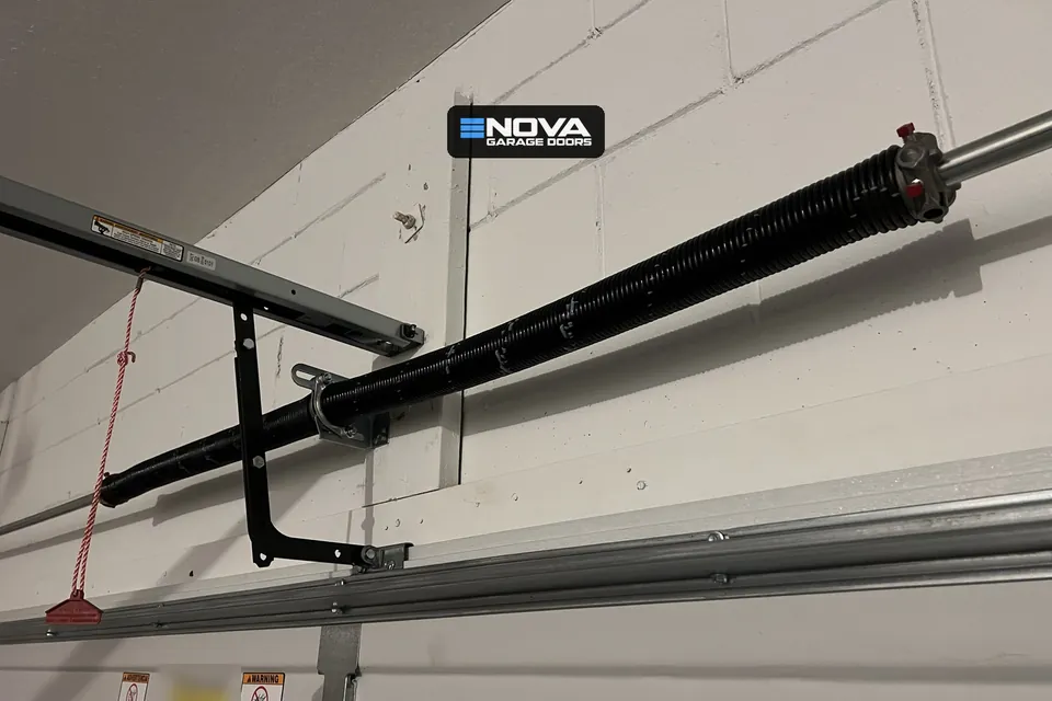 Garage door torsion spring and opener arm after a repair